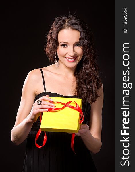 Surprised beautiful woman holding a gift. Surprised beautiful woman holding a gift
