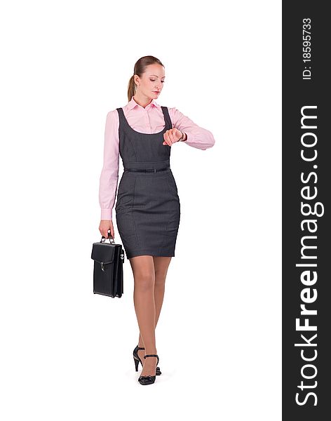 Young businesswoman standing with briefcase looking at watch. Young businesswoman standing with briefcase looking at watch