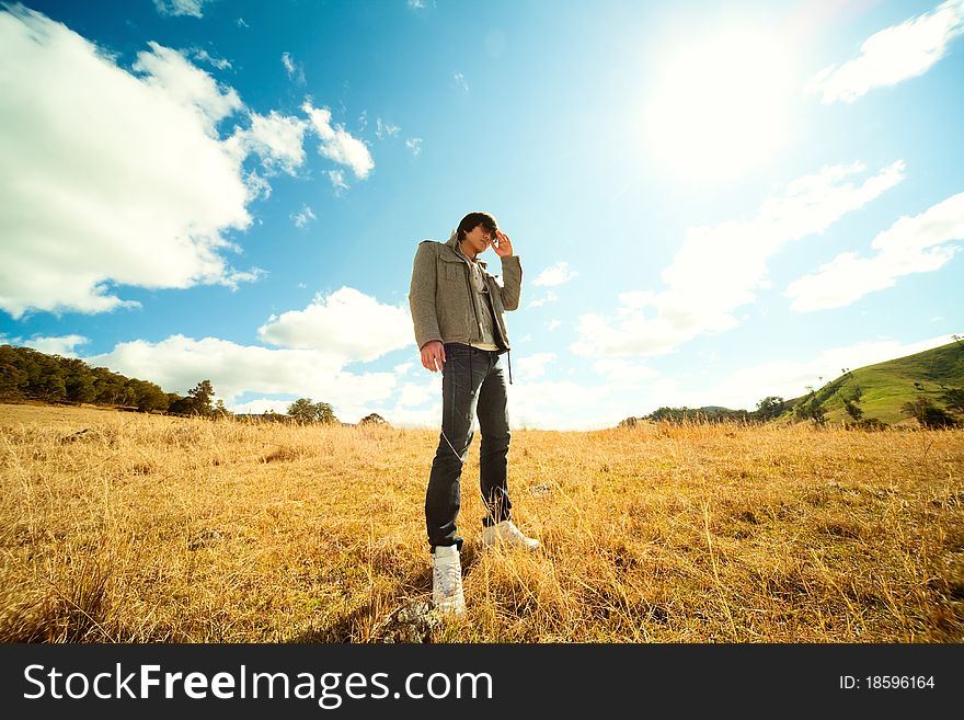 Young man rest on golden field. Young man rest on golden field.