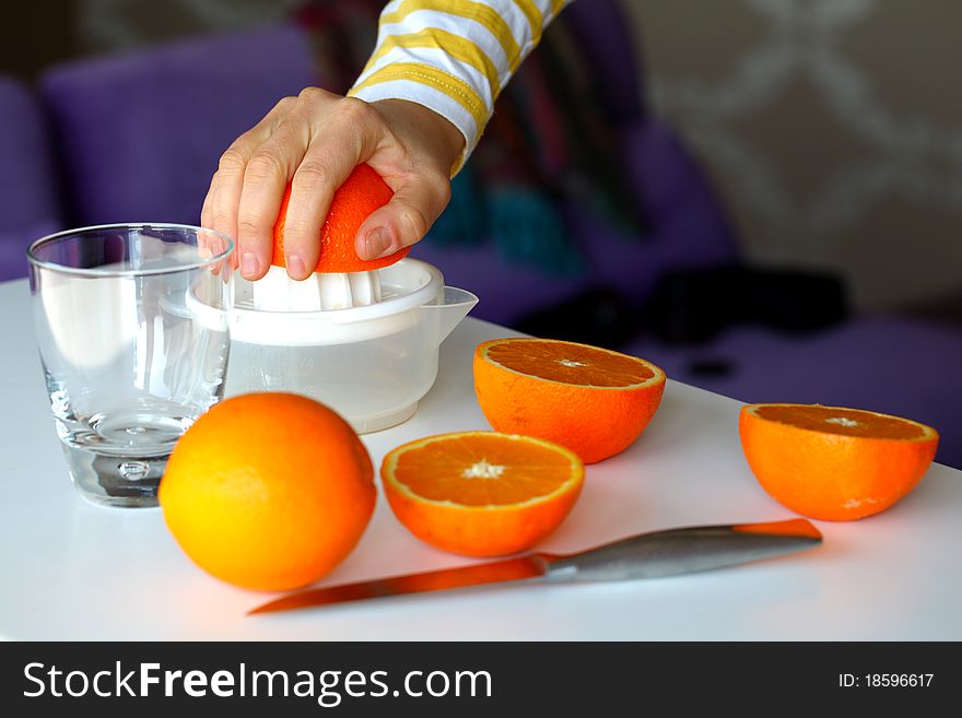 Squeezing oranges for orange juice in the morning for breakfast