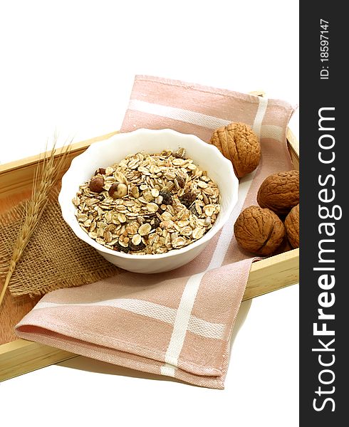 Muesli of oats with raisin and walnuts isolated on white background