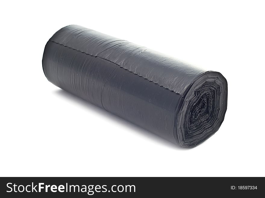 One black rolled garbage bag. Isolated on white with soft shadow