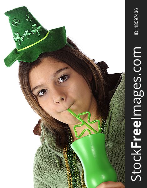 A young teen sipping through a shamrock-shaped straw as she celebrates St. Patrick's Day. Isolated on white. A young teen sipping through a shamrock-shaped straw as she celebrates St. Patrick's Day. Isolated on white.