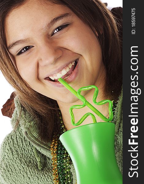 Closeup portrait of an attractive young teen laughing as she enjoys a St. Patrick's Day drink. Closeup portrait of an attractive young teen laughing as she enjoys a St. Patrick's Day drink.