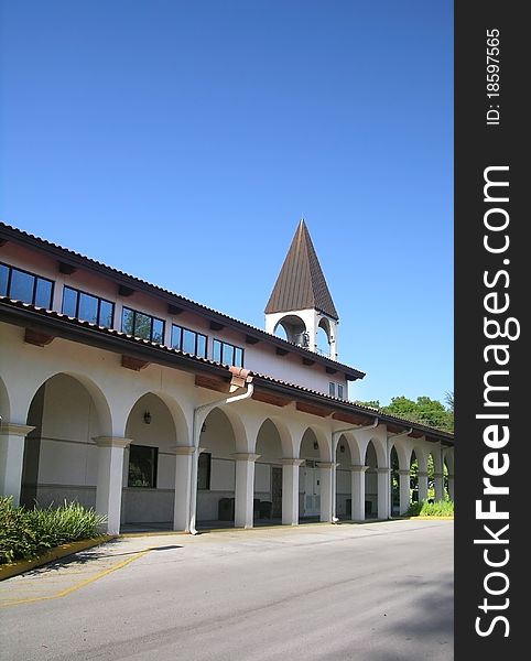 Arched walkway leading to a small church.