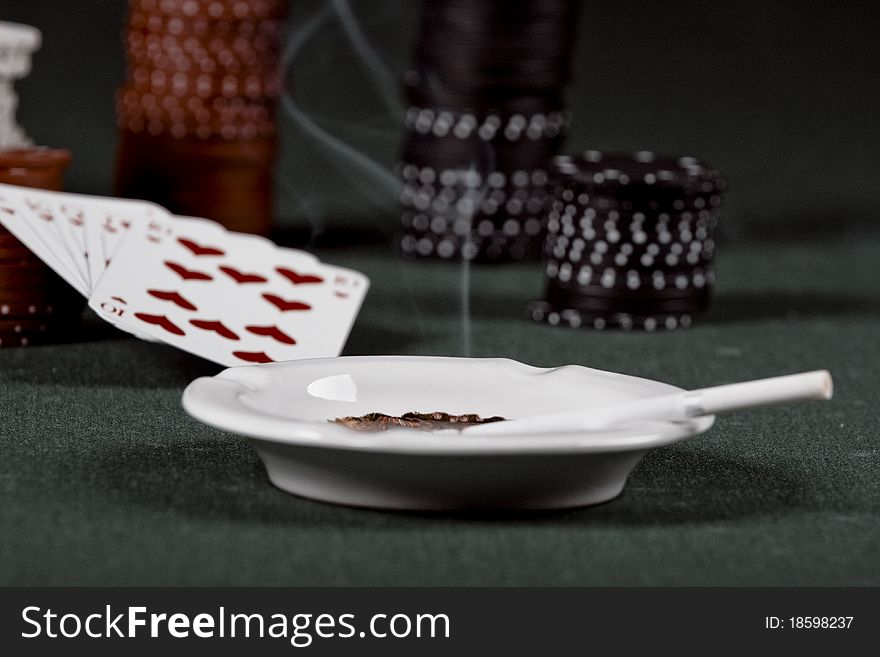 Casino gambling chips and playing cards on green table. Casino gambling chips and playing cards on green table