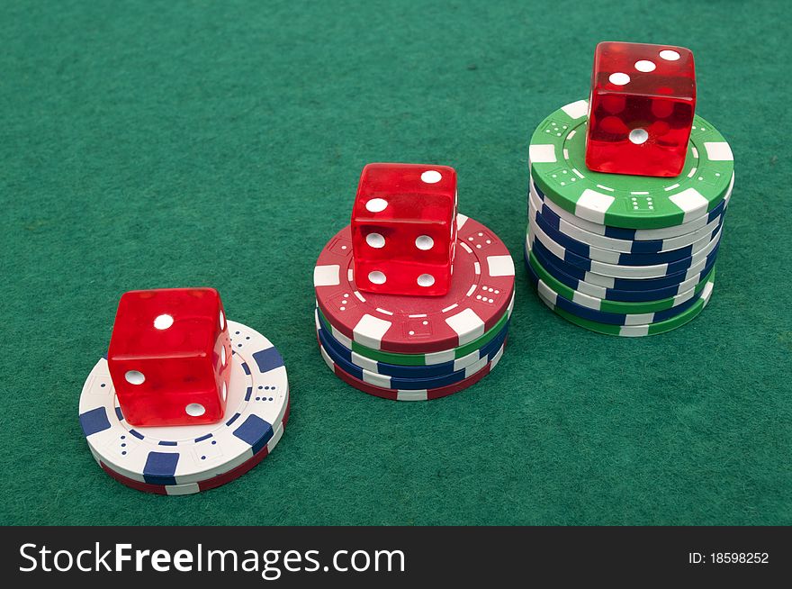 Dice and chips on a green table