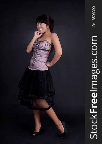 Attractive young Asian woman posing in fashion dress