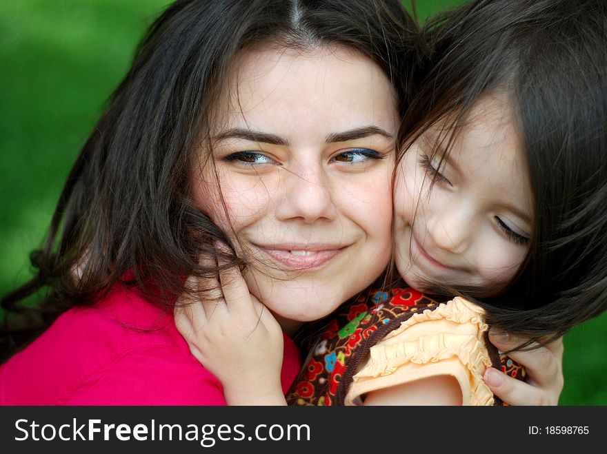 Small girl hugs her mother