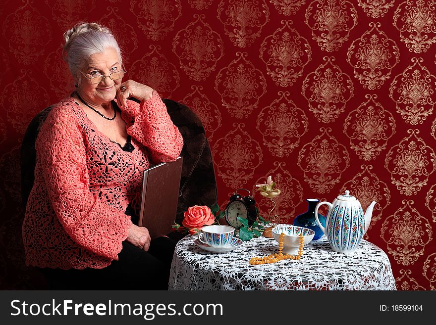 Portrait of a smiling senior woman having a rest at home. Portrait of a smiling senior woman having a rest at home.