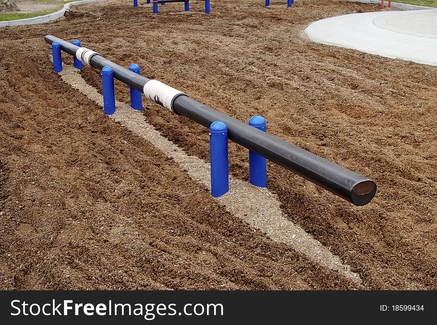 Balance beam and bark padding at playground park