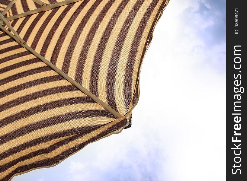 Detail of beach umbrella opposite sun light