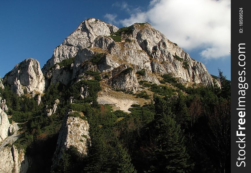 Stony mountain peak with blue sky in the background.