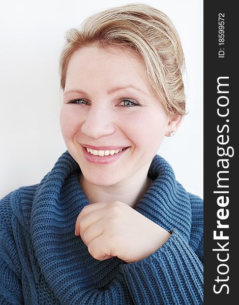 Young woman in the dark-blue sweater smiles