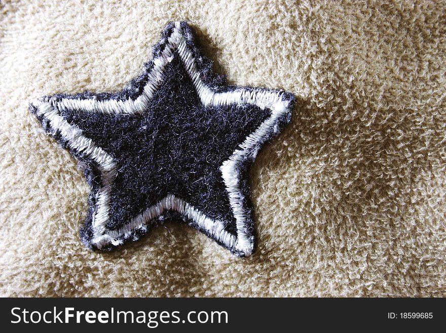 Soft fleece fabric with a star to be used as a background. Soft fleece fabric with a star to be used as a background