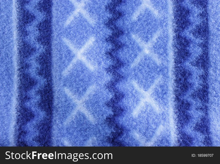 Warm blue fleece patterned blanket to be used as a background. Warm blue fleece patterned blanket to be used as a background