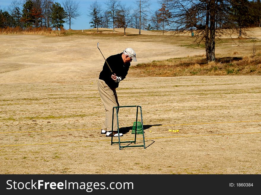 Photographed senior citizen golfer at local course in Georgia. Photographed senior citizen golfer at local course in Georgia.