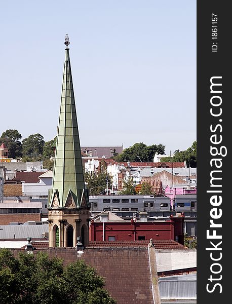 Church Tower Over City Roofs In Sydney Australia On A Sunny Summer Day, Clear Blue Sky