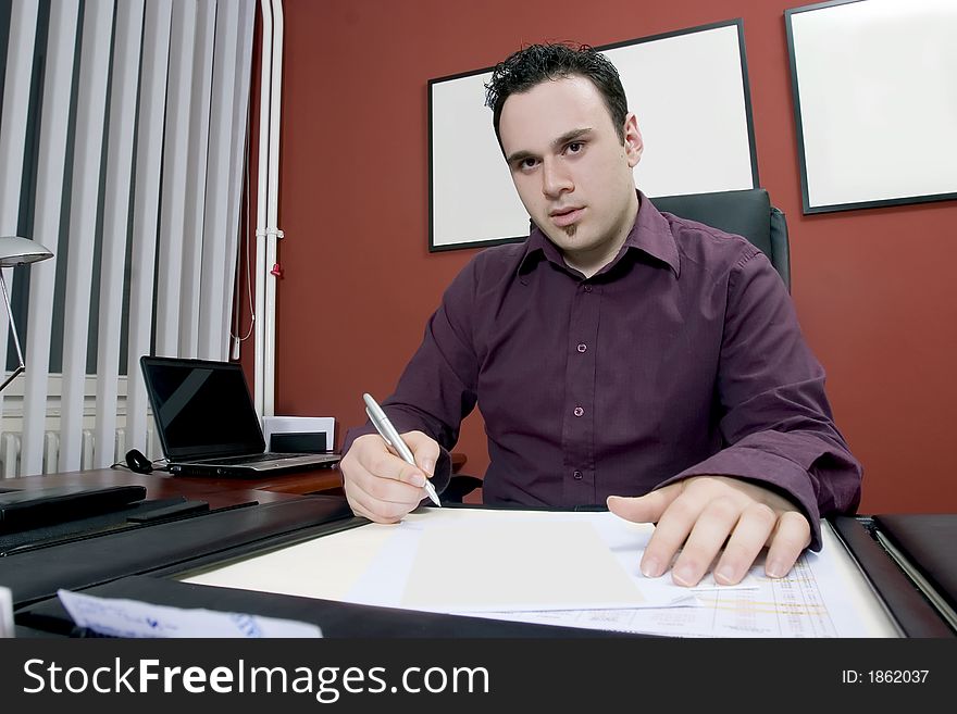 Businessman in his office writing document