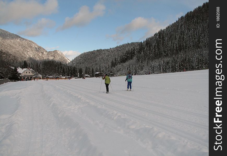 Beautiful winter landscape showing a cross-country ski run with people skiing