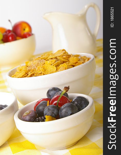 Everything you need for a healthy start to the day. Shallow focus on bowl of berries in foreground. Everything you need for a healthy start to the day. Shallow focus on bowl of berries in foreground.