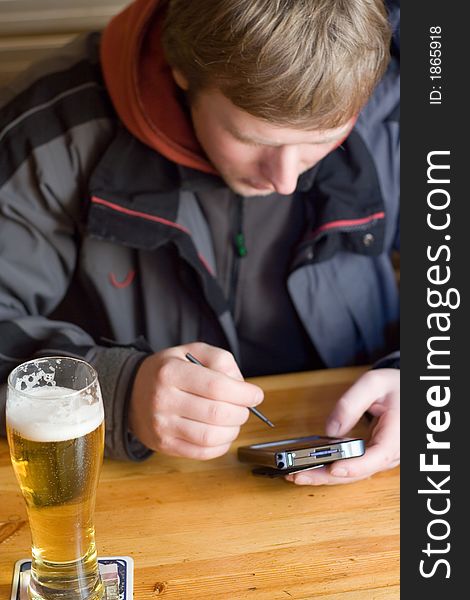 Man With Beer And Palm-size Computer