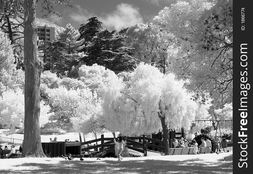 Little girl playing in a city park infrared black and white. Little girl playing in a city park infrared black and white.