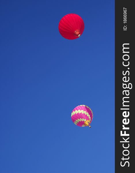 Two hot-air balloon floating high in a clear blue sky. Two hot-air balloon floating high in a clear blue sky.