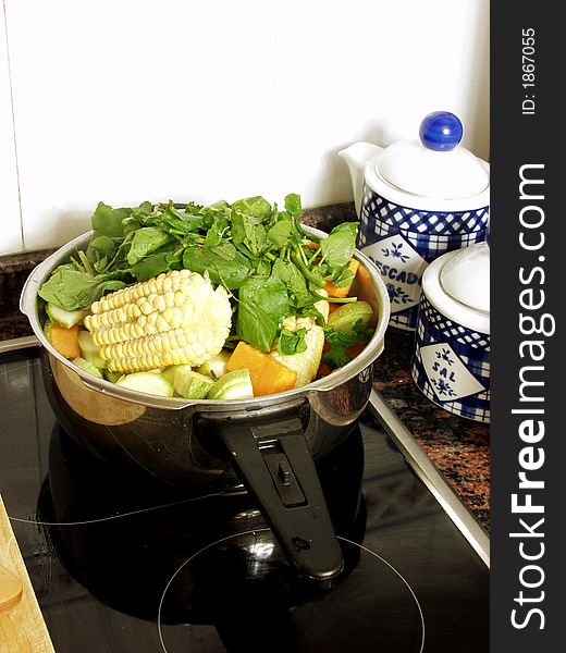 Preparing a vegetables soup in the pressure cooker on the kitchen