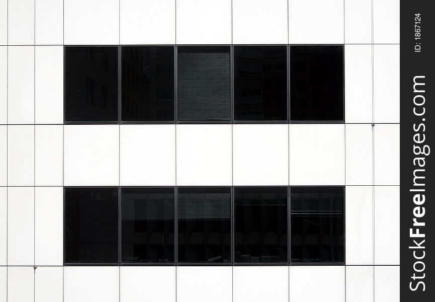 Modern Black Glass Windows In A White Urban Office Building Facade. Modern Black Glass Windows In A White Urban Office Building Facade