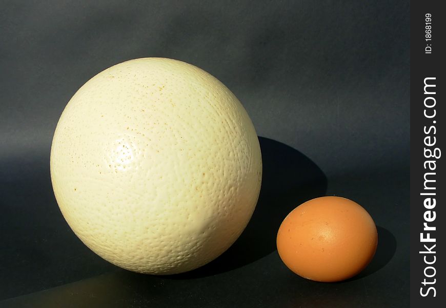 Two brown eggs over black background