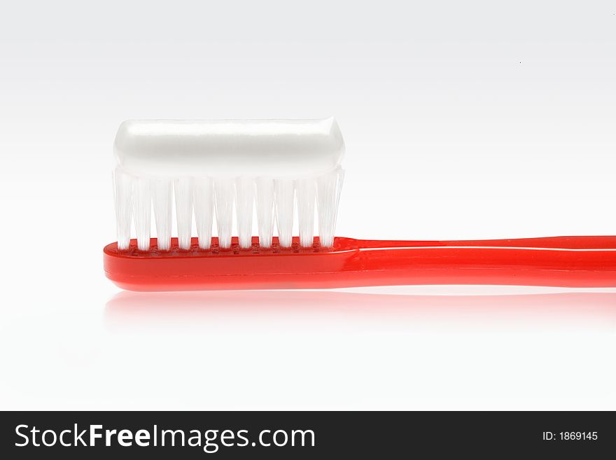 Red toothbrush with white tooth paste. Red toothbrush with white tooth paste
