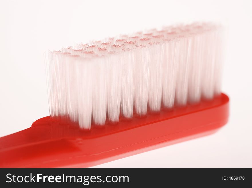 Red toothbrush with white bristles