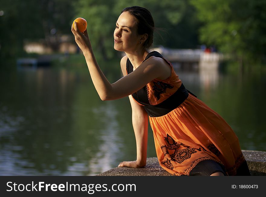 Girl looking at Mandarin orange fruit. Girl looking at Mandarin orange fruit