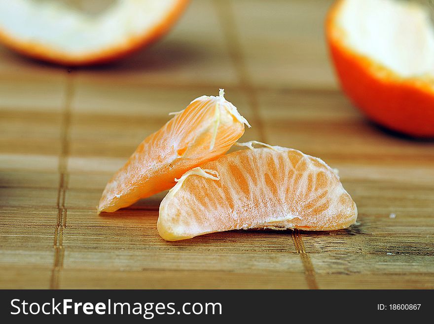 Delicious juicy tangerine on bamboo napkin close up