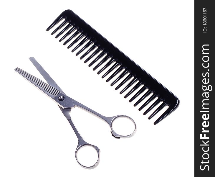 Hairdressing scissors and comb isolated on a white background.