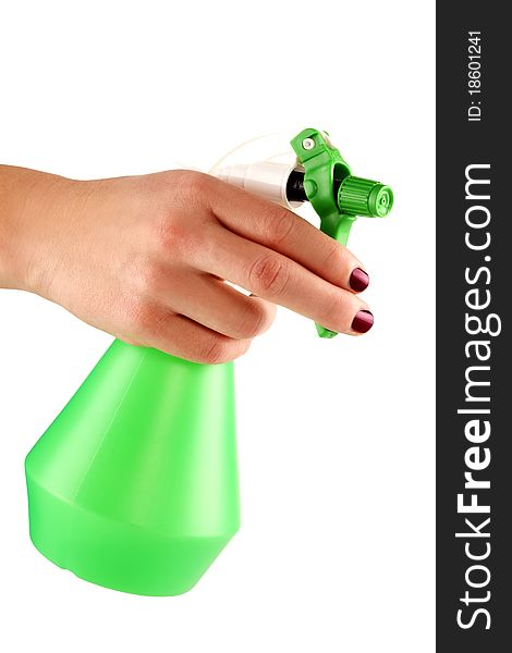 Hand of a young female holding the green sprayer for flowers. Hand of a young female holding the green sprayer for flowers