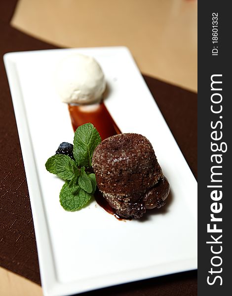 Chocolate Dessert on a square dish with fresh mint and ice cream