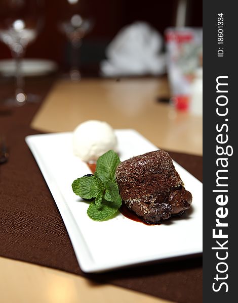 Chocolate Dessert on a square dish with fresh mint and ice cream. Chocolate Dessert on a square dish with fresh mint and ice cream