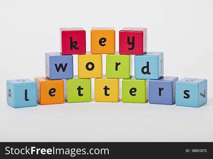 Wooden blocks with letters stacked up on white background. Wooden blocks with letters stacked up on white background