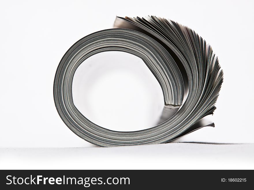 Rolled up magazine on white background. Rolled up magazine on white background