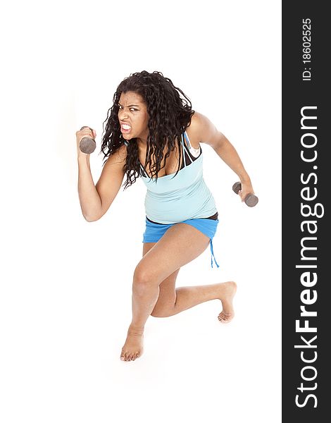 An African American woman is working out with a crazy expression. An African American woman is working out with a crazy expression.