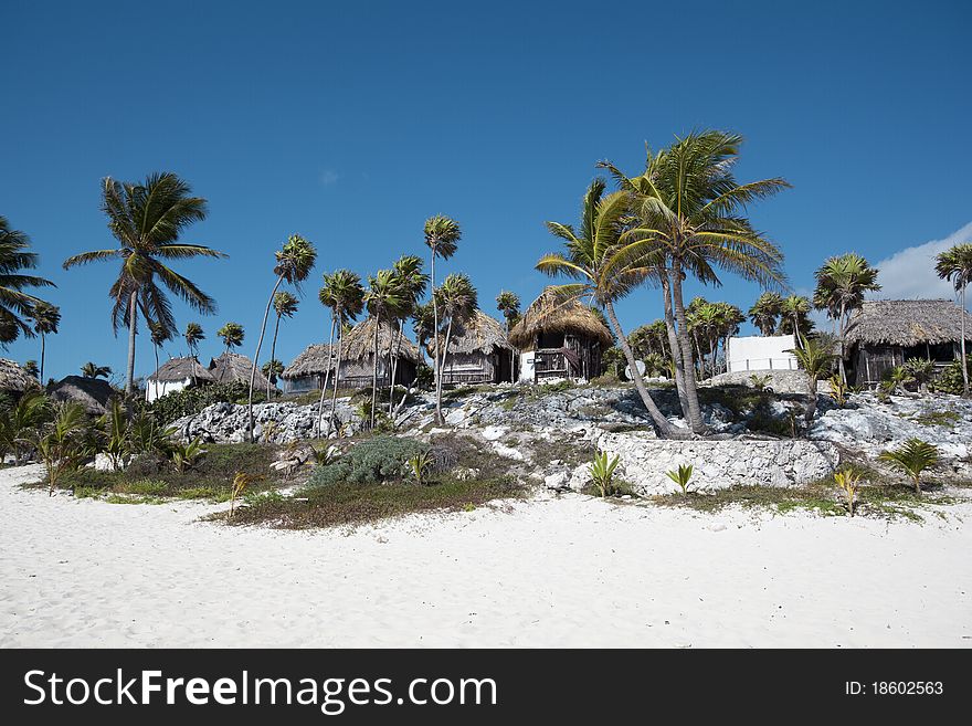 Beach bungalows on a tropical island on the East Coast of Mexico