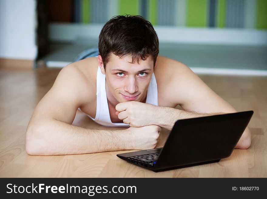 A Young Man In A White Robe With Laptop