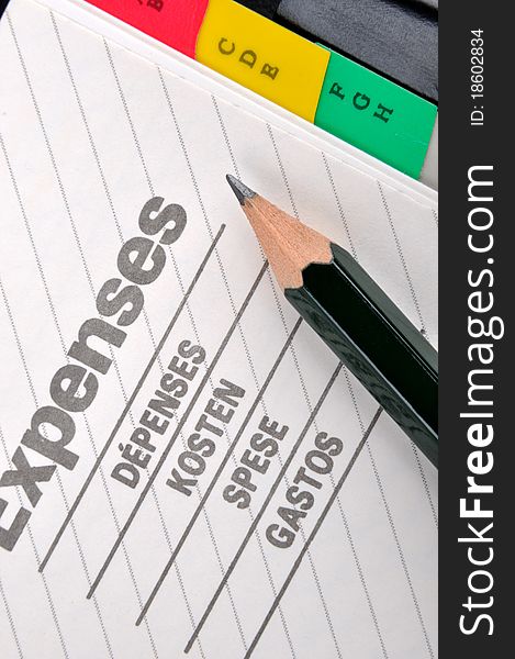 Expenses book page or record and a pencil, shown as woking on expenses, cost, saving, charge, payout, consumption, purchsing and other related business concept. Expenses book page or record and a pencil, shown as woking on expenses, cost, saving, charge, payout, consumption, purchsing and other related business concept.