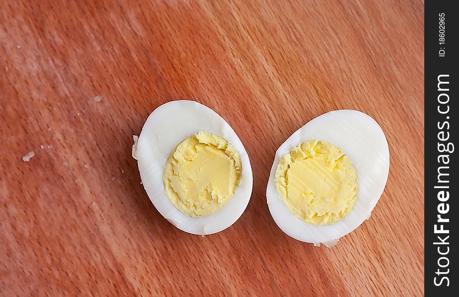 A hard boiled egg sliced in two ready to be eaten.