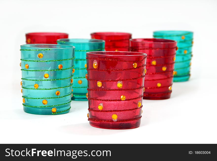 Aqua blue and red votive decorative candle holders with glitter and jewels. Aqua blue and red votive decorative candle holders with glitter and jewels