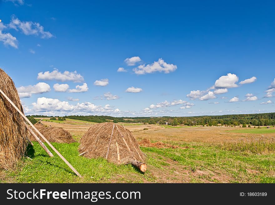 Blue sky and clouds over green hills