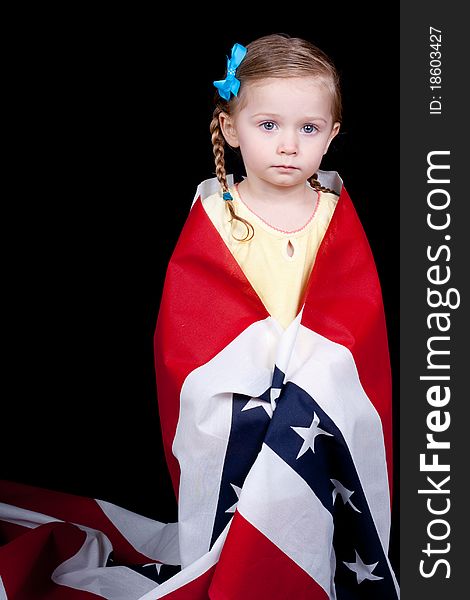 An innocent American girl with a patriotic fabric wrapped around her.