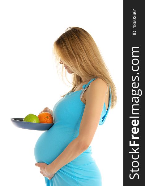 Pregnant woman holding an apple and an orange in a pan isolated on white. Pregnant woman holding an apple and an orange in a pan isolated on white